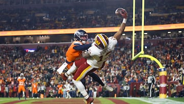 Nov 30, 2025; Landover, Maryland, USA; Washington Commanders wide receiver Treylon Burks (13) makes a catch for a touchdown defended by Denver Broncos cornerback Riley Moss (21) in the third quarter of the game at Northwest Stadium. Mandatory Credit: Peter Casey-Imagn Images