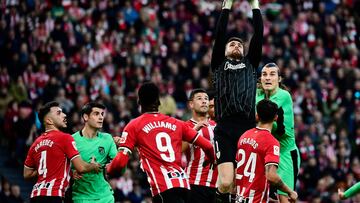 Athletic Bilbao's Spanish goalkeeper #01 Unai Simon jumps to make a save during the Spanish league football match between Athletic Club Bilbao and Club Atletico de Madrid at the San Mames stadium in Bilbao on December 16, 2023. (Photo by ANDER GILLENEA / AFP)