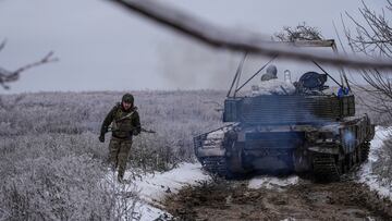A Ukrainian serviceman of the 92nd Ivan Sirko Separate Assault Brigade walks next to a T-64 tank near the town of Bakhmut, amid Russia’s attack on Ukraine, in Donetsk region, Ukraine December 13, 2023. REUTERS/Inna Varenytsia