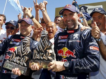 Peugeot driver Stephane Peterhansel and co-pilot Jean Paul Cottret hold their trophies as they celebrate with members of the Peugeot team after they won the Dakar Rally 2016 in Rosario, Argentina, January 16, 2016. REUTERS/Enrique Marcarian        TPX IMA