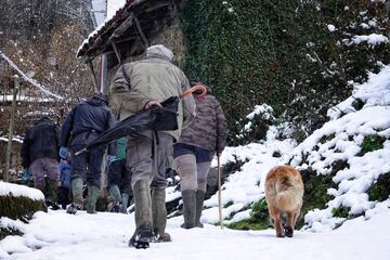 Varias personas caminan por una calle nevada, a 18 de enero de 2023, en San Juan de Beleño, Ponga, Asturias. La Agencia Estatal de Meteorología (Aemet) ha elevado a naranja el nivel de alarma en Asturias, tanto por fenómenos costeros, como por acumulaciones de nieve que podrían ser de 20 centímetros en cotas superiores a los 1.000 metros. 