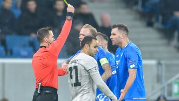 Hoffenheim's Hungarian forward Adam Szalai receives a yellow card by the referee during the UEFA Champions League Group F football match TSG 1899 Hoffenheim v FC Shakhtar Donetsk in Sinsheim, southern Germany, on November 27, 2018. - Hoffenheim'
