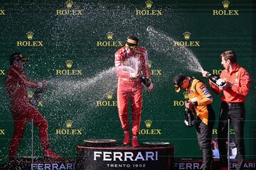 (L-R) Second-placed Ferrari's Monegasque driver Charles Leclerc, winner Ferrari's Spanish driver Carlos Sainz Jr and third-placed McLaren's British driver Lando Norris celebrate on the podium after winning the Australian Formula One Grand Prix at Albert Park Circuit in Melbourne on March 24, 2024. (Photo by WILLIAM WEST / AFP) / -- IMAGE RESTRICTED TO EDITORIAL USE - STRICTLY NO COMMERCIAL USE --