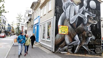 FILE PHOTO: People walk past artwork on the side of a shop as the outbreak of the coronavirus disease (COVID-19) continues in Reykjavik, Iceland, September 3, 2020. REUTERS/John Sibley/File Photo