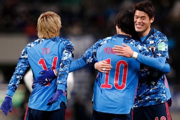 01 February 2022, Japan, Saitama: Japan's Takumi Minamino (C) celebrates scirung his side's first goal with teammates during the FIFA 2022 World Cup Asian qualification soccer match between Japan and Saudi Arabia at Saitama Stadium.