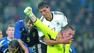 Gemany&#039;s Kevin Kuranyi, center, fights for the ball against keeper Robert Douglas, Steven Pressley and Jacki McNamara, from left, of Scotland during the EURO 2004 Group 5 qualifying match between Germany and Scotland  in the Westphalia Stadium in Dor