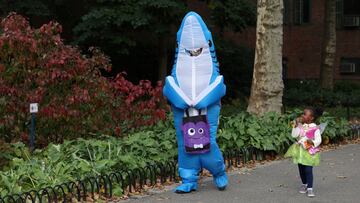 People dressed as Baby Shark and Tinker Bell walk in Stuy Town on Halloween in Manhattan, New York City, U.S., October 31, 2022. REUTERS/Andrew Kelly
