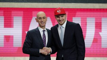 FILE PHOTO:  Luka Doncic greets NBA commissioner Adam Silver (L) after being selected as the number three overall pick to the Atlanta Hawks in the first round of the 2018 NBA Draft at the Barclays Center in Brooklyn, NY, U.S., June 21, 2018.   Mandatory C