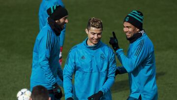MADRID, SPAIN - FEBRUARY 13: Cristiano Ronaldo (2ndR) of Real Madrid CF jokes with his teammatesKarim Benzema (L) and Carlos Casemiro during a training session at Valdebebas training ground ahead their Round of 16 first leg UEFA Champions League match ag