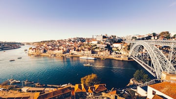 oporto city with douro river and dom luiz bridge under blue sky, portugal.
