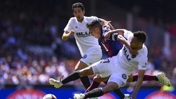 VALENCIA, SPAIN - APRIL 28: Francis Coquelin of Valencia competes for the ball with Fabian Orellana of Eibar during the La Liga match between Valencia CF and SD Eibar at Estadio Mestalla on April 28, 2019 in Valencia, Spain. (Photo by Quality Sport Images