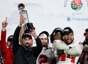 Head coach Ryan Day of the Ohio State Buckeyes holds up the The Leishman Trophy after defeating the Oregon Ducks 41-21 