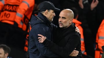 Bayern Munich's German head coach Thomas Tuchel (L) and Manchester City's Spanish manager Pep Guardiola (R) embrace after the UEFA Champions League quarter final, first leg football match between Manchester City and Bayern Munich at the Etihad Stadium in Manchester, north-west England, on April 11, 2023. - Manchester City won the game 3-0. (Photo by Paul ELLIS / AFP)