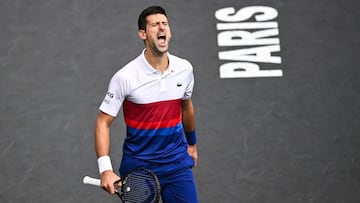 Serbia's Novak Djokovic reacts as he plays against Russia's Daniil Medvedev during their men's single final tennis match on the last day of the ATP Paris Masters at The AccorHotels Arena in Paris on November 7, 2021. (Photo by Anne-Christine POUJOULAT / AFP)