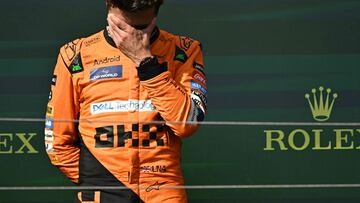 McLaren's British driver Lando Norris reacts on the podium after the Formula One Hungarian Grand Prix at the Hungaroring race track in Mogyorod near Budapest on July 21, 2024. (Photo by Attila KISBENEDEK / AFP)