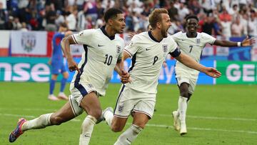 England's midfielder #10 Jude Bellingham celebrates with England's forward #09 Harry Kane after scoring his team's first goal during the UEFA Euro 2024 round of 16 football match between England and Slovakia at the Arena AufSchalke in Gelsenkirchen on June 30, 2024. (Photo by Adrian DENNIS / AFP)