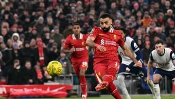 Liverpool's Egyptian striker #11 Mohamed Salah shoots from the penalty spot to score the team's second goal during the English League Cup semi-final second leg football match between Liverpool and Tottenham Hotspur at Anfield in Liverpool, north west England on February 6, 2025. (Photo by Oli SCARFF / AFP) / RESTRICTED TO EDITORIAL USE. No use with unauthorized audio, video, data, fixture lists, club/league logos or 'live' services. Online in-match use limited to 120 images. An additional 40 images may be used in extra time. No video emulation. Social media in-match use limited to 120 images. An additional 40 images may be used in extra time. No use in betting publications, games or single club/league/player publications. /