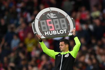 Fourth official Andy Madley lifts the LED board to communicate in numbers.