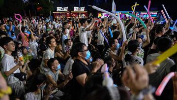 This photo taken on August 4, 2020 shows people participating in a music festival in Wuhan in Chinax92s central Hubei province. - The city's convalescence since a 76-day quarantine was lifted in April has brought life and gridlocked traffic back onto its streets, even as residents struggle to find their feet again. Long lines of customers now stretch outside breakfast stands, a far cry from the terrified crowds who queued at city hospitals in the first weeks after a city-wide lockdown was imposed in late January to curb the spread of the COVID-19 coronavirus. (Photo by Hector RETAMAL / AFP)