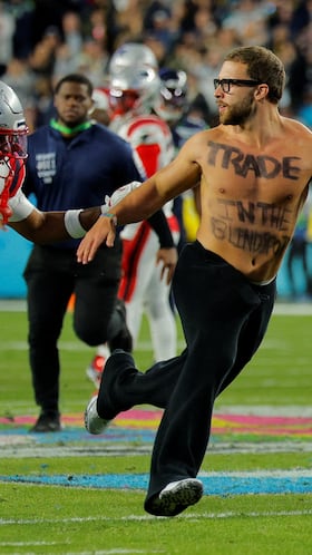 Football - NFL - Super Bowl LX - New England Patriots v Seattle Seahawks - Levi's Stadium, Santa Clara, California, United States - February 8, 2026 Pitch invader is chased by New England Patriots' Kyle Williams during the game REUTERS/Mike Blake TPX IMAGES OF THE DAY