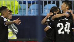 Sevilla&#039;s Argentinian midfielder Joaquin Correa (R) celebrates a goal with teammates during the Spanish league football match Malaga CF against Sevilla FC at La Rosaleda stadium in Malaga on February 28, 2018. / AFP PHOTO / JORGE GUERRERO