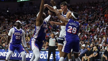 Oct 11, 2024; Des Moines, Iowa, USA; Minnesota Timberwolves center Luka Garza (55) passes the ball between defenders Philadelphia 76ers guard Ricky Council IV (14) and Philadelphia 76ers forward Guerschon Yabusele (28) at Wells Fargo Arena. The Timberwolves beat the 76ers 121 to 111. Mandatory Credit: Reese Strickland-Imagn Images