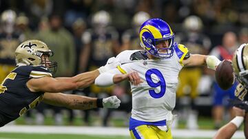 Nov 20, 2022; New Orleans, Louisiana, USA; Los Angeles Rams quarterback Matthew Stafford (9) is grabbed by New Orleans Saints linebacker Kaden Elliss (55) in the second quarter at the Caesars Superdome. Mandatory Credit: Chuck Cook-USA TODAY Sports