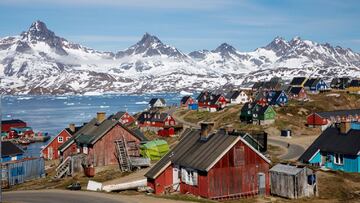 FILE PHOTO: Snow covered mountains rise above the harbour and town of Tasiilaq, Greenland, June 15, 2018. REUTERS/Lucas Jackson/File Photo