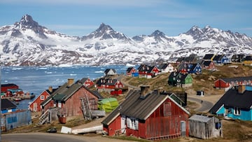 FILE PHOTO: Snow covered mountains rise above the harbour and town of Tasiilaq, Greenland, June 15, 2018. REUTERS/Lucas Jackson/File Photo