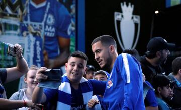 Chelsea's Eden Hazard poses for a photo with a fan as he arrives at the stadium before the match