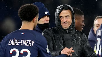 Paris Saint-Germain's Spanish headcoach Luis Enrique (2nd L) celebrates with Paris Saint-Germain's French midfielder #33 Warren Zaire-Emery (L) at the end of the French L1 football match between Rennes and Paris Saint-Germain (PSG) at the Parc des Princes stadium in Paris on February 25, 2024. (Photo by FRANCK FIFE / AFP)