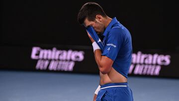 Serbia's Novak Djokovic wipes his face after a point against Croatia's Dino Prizmic during their men's singles match on day one of the Australian Open tennis tournament in Melbourne on January 14, 2024. (Photo by WILLIAM WEST / AFP) / -- IMAGE RESTRICTED TO EDITORIAL USE - STRICTLY NO COMMERCIAL USE --