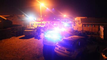 Police are seen outside a township pub in South Africa's southern city of East London on June 26, 2022, after 20 teenagers died inside. - At least 20 teenagers, the youngest aged just 13 years, have died at a township pub in South Africa's southern city of East London, but the cause of the deaths is still unclear. Crowds of people including parents whose children were missing gathered outside the tavern located along a street in a residential township as mortuary vehicles collected bodies, according to an AFP correspondent. (Photo by AFP) (Photo by STR/AFP via Getty Images)