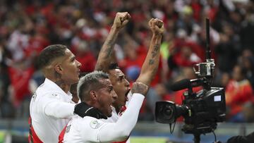 Peru's Victor Yotun, right, celebrates scoring his side's second goal with teammates Miguel Angel Trauco, center, and Paolo Guerrero during a Copa America semifinal soccer match against Chile at the Arena do Gremio in Porto Alegre, Brazil, Wedne