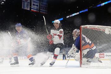 Jack Hughes, número 86 de los New Jersey Devils, se dispone a recibir y encarar al guardameta de los New York Islanders, Semyon Varlamov, durante el primer periodo del partido de la NHL de hockey disputado entre ambos conjuntos en el Nassau Coliseum de Uniondale, Nueva York. Los Islanders se impusieron por 4-1.