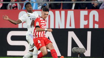 Girona's Spanish defender Arnau Martinez (R) vies with Real Madrid's Brazilian forward Vinicius Junior during the Spanish league football match between Girona FC and Real Madrid CF at the Montilivi stadium in Girona on April 25, 2023. (Photo by LLUIS GENE / AFP)