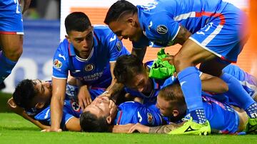 Jose Rivero (down, C) of Cruz Azul celebrates with teammates after scoring goal against Leon during their Mexican Apertura 2022 tournament playoff football match at Azteca Stadium in Mexico City, on October 8, 2022. (Photo by CLAUDIO CRUZ / AFP)