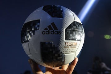 A participant holds the official match ball for the 2018 World Cup, named "Telstar 18", during its unveiling ceremony in Moscow on November 9, 2017