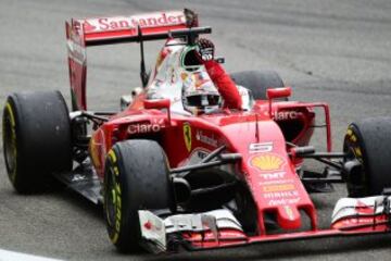 Scuderia Ferrari's German driver Sebastian Vettel celebrates placing third in the Italian Formula One Grand Prix at the Autodromo Nazionale circuit in Monza on September 4, 2016.