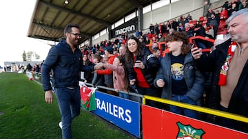 Soccer Football - National League - Wrexham v Notts County - Racecourse Ground, Wrexham, Britain - April 10, 2023 Wrexham co-owner Ryan Reynolds with fans in the stands before the match Action Images via Reuters/Andrew Boyers EDITORIAL USE ONLY. No use with unauthorized audio, video, data, fixture lists, club/league logos or 'live' services. Online in-match use limited to 75 images, no video emulation. No use in betting, games or single club /league/player publications.  Please contact your account representative for further details.