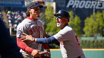 CLEVELAND, OHIO - APRIL 27: First base coach Jos� David Flores #58 of the Boston Red Sox holds back Jarren Duran #16 as Duran yells at a fan during the seventh inning against the Cleveland Guardians at Progressive Field on April 27, 2025 in Cleveland, Ohio.   Nick Cammett/Getty Images/AFP (Photo by Nick Cammett / GETTY IMAGES NORTH AMERICA / Getty Images via AFP)