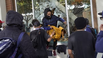  A person jumps from a store window during widespread protests and unrest in response to the death of George Floyd on May 31, 2020 in Santa Monica, California. 