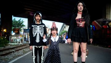 A family wearing Halloween-themed costumes pose as they attend Thailand's Goosebumps Festival 2024 at a train factory in Bangkok, Thailand, October 31, 2024. REUTERS/Athit Perawongmetha