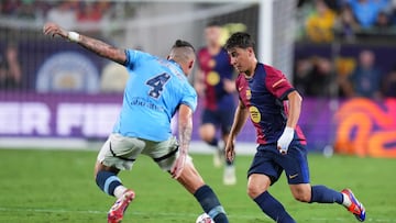 ORLANDO, FLORIDA - JULY 30: Pablo Torre #6 of FC Barcelona dribbles the ball against Kalvin Phillips #4 of Manchester City in the first half during a pre-season match between Manchester City and FC Barcelona at Camping World Stadium on July 30, 2024 in Orlando, Florida. Rich Storry/Getty Images/AFP (Photo by Rich Storry / GETTY IMAGES NORTH AMERICA / Getty Images via AFP)