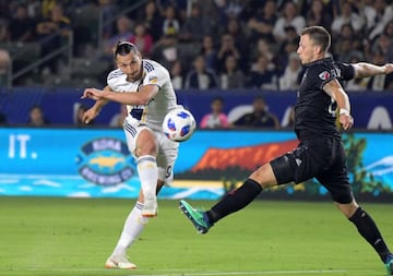 Jul 4, 2018; Carson, CA, USA; LA Galaxy forward Zlatan Ibrahimovic (9) kicks against D.C. United defender Frederic Brillant (13) in the second half at StubHub Center. The teams played to a 2-2 tie.