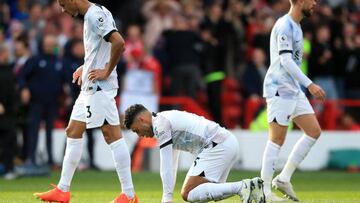 Liverpool's Brazilian midfielder Fabinho (L), Liverpool's English midfielder Alex Oxlade-Chamberlain (C) and Liverpool's English midfielder Jordan Henderson (R) react to their defeat on the pitch after the English Premier League football match between Nottingham Forest and Liverpool at The City Ground in Nottingham, central England, on October 22, 2022. - Nottingham Forest won the game 1-0. - RESTRICTED TO EDITORIAL USE. No use with unauthorized audio, video, data, fixture lists, club/league logos or 'live' services. Online in-match use limited to 120 images. An additional 40 images may be used in extra time. No video emulation. Social media in-match use limited to 120 images. An additional 40 images may be used in extra time. No use in betting publications, games or single club/league/player publications. (Photo by Lindsey Parnaby / AFP) / RESTRICTED TO EDITORIAL USE. No use with unauthorized audio, video, data, fixture lists, club/league logos or 'live' services. Online in-match use limited to 120 images. An additional 40 images may be used in extra time. No video emulation. Social media in-match use limited to 120 images. An additional 40 images may be used in extra time. No use in betting publications, games or single club/league/player publications. / RESTRICTED TO EDITORIAL USE. No use with unauthorized audio, video, data, fixture lists, club/league logos or 'live' services. Online in-match use limited to 120 images. An additional 40 images may be used in extra time. No video emulation. Social media in-match use limited to 120 images. An additional 40 images may be used in extra time. No use in betting publications, games or single club/league/player publications. (Photo by LINDSEY PARNABY/AFP via Getty Images)