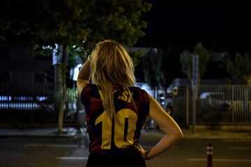 Fanática del Barça desolada e incrédula con la camiseta de Leo Messi frente a las oficinas del equipo catalán.