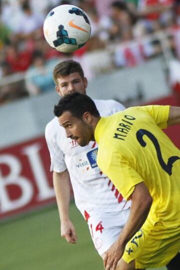 El defensa del Sevilla FC, Alberto Moreno (arriba), realiza un pase por encima del defensa del Villarreal CF, Mario Gaspar, durante el partido correspondiente a la trigésimo sexta jornada de Liga.