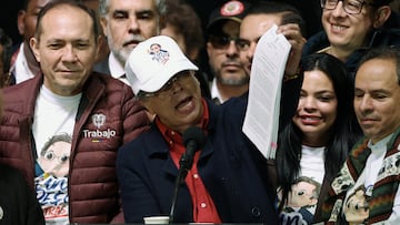 Colombian President Gustavo Petro shows the new minimum wage decree document during a demonstration in support of its defense, after the Council of State temporarily suspended the decree that would have raised it, in Bogota, Colombia February 19, 2026. REUTERS/Luisa Gonzalez