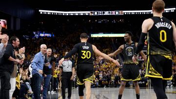 Stephen Curry #30 of the Golden State Warriors is congratulated by Andrew Wiggins #22 after he made a basket against the Sacramento Kings in the second half of Game Three of the Western Conference First Round Playoffs at Chase Center on April 20, 2023 in San Francisco, California.